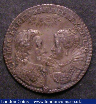 Marriage of Charles I and Henrietta Maria 1625 23mm diameter in Silver by Briot? Eimer 105 Obverse Facing busts above celestial rays.CH.MAG.ET.HEN.MA.BRIT.REX.ET.REG Reverse Cupid walking, right, scatters roses and lilies. Above, celestial rays. FVNDIT.AMOR.LILIA.MIXTA.ROSIS Good Fine with a crease mark : Medals : Auction 142 : Lot 1194