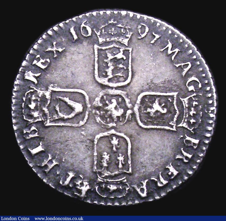 London Coins : A155 : Lot 667 : Sixpence 1697 First Bust, Small Crowns, E over B below bust ESC 1560A Near VF with deep grey tone, E...