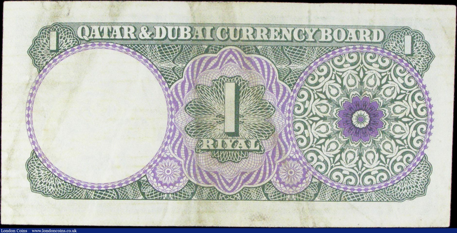 London Coins : A156 : Lot 292 : Qatar & Dubai 1 riyal issued 1960s series A/11 331108, small inked number on face & dirt on ...