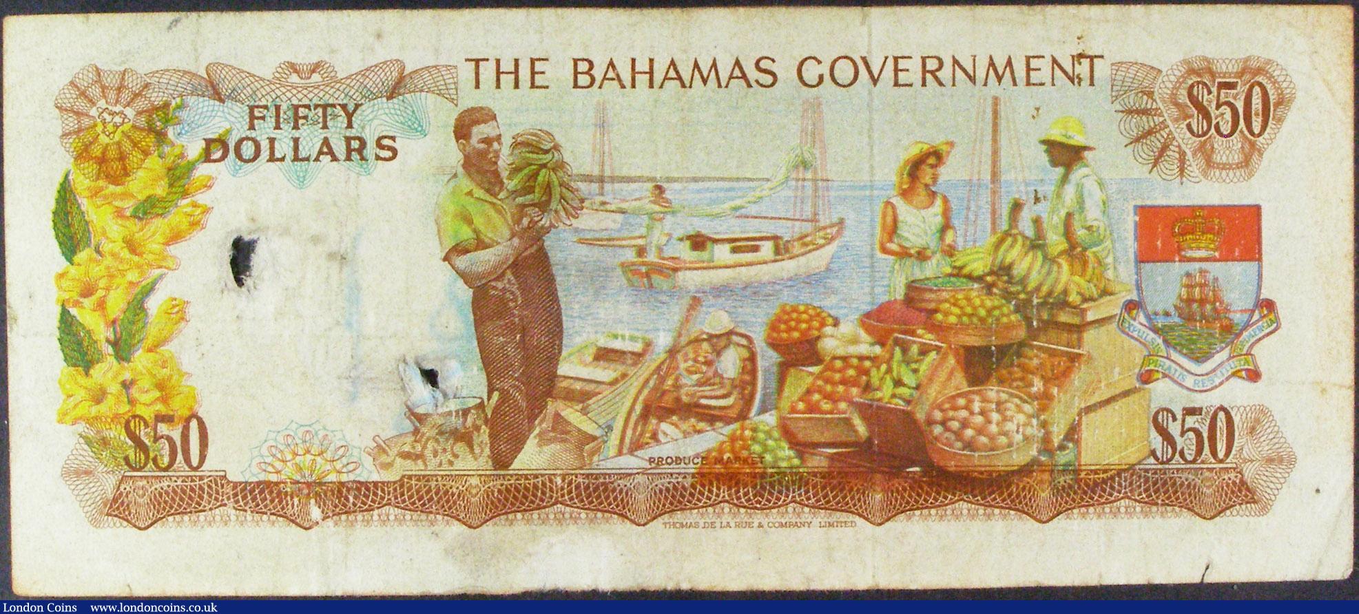 London Coins : A157 : Lot 105 : Bahamas Government $50 issued 1965 series A081374, Pick24a, two holes at right, penned numbers on fa...