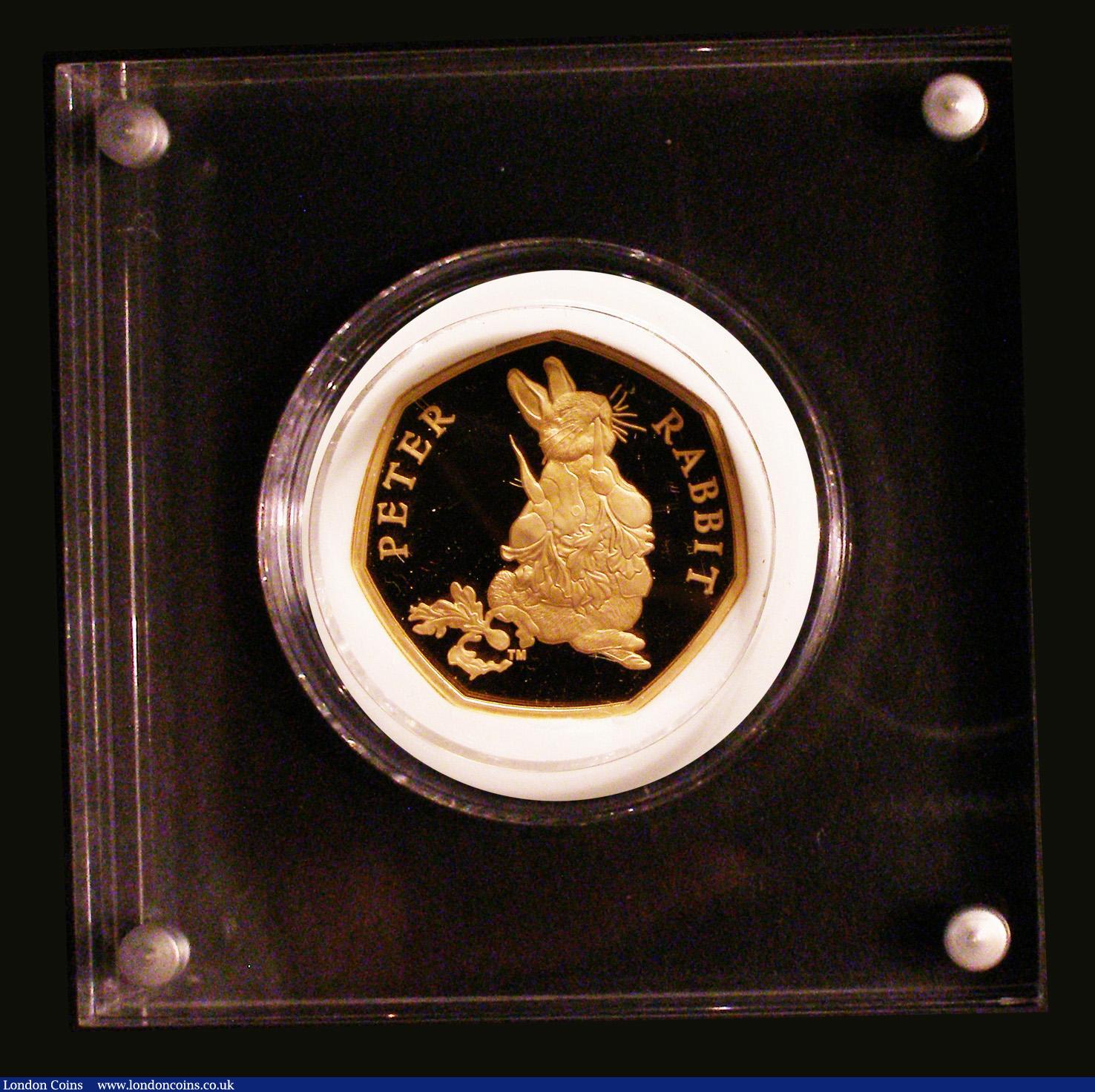 London Coins : A183 : Lot 176 : Fifty Pence 2018 Peter Rabbit Gold Proof FDC the coin in the paper weight style Perspex holder then ...