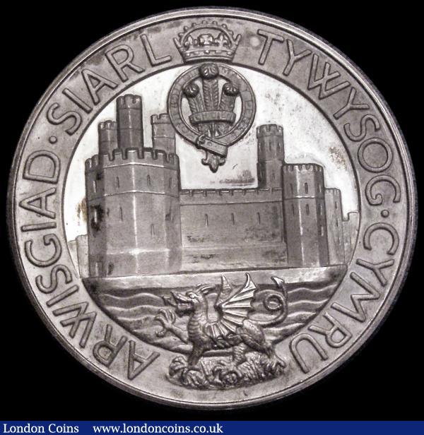 Investiture of Prince Charles as Prince of Wales 1969 39mm diameter in silver, Obverse: Bust left draped and crowned, INVESTITURE OF CHARLES  . PRINCE OF WALES. CAERNARVON JULY 1969 in the fields, Reverse: Caernarvon castle, Prince of Wales feathers and motto above, Welsh Dragon below, ARWISGIAD . SIARL TYWYSOG . CYMRU, 26.75 grammes, EF with some small areas of dark toning in places, officially numbered on the edge : Medals : Auction 185 : Lot 1292